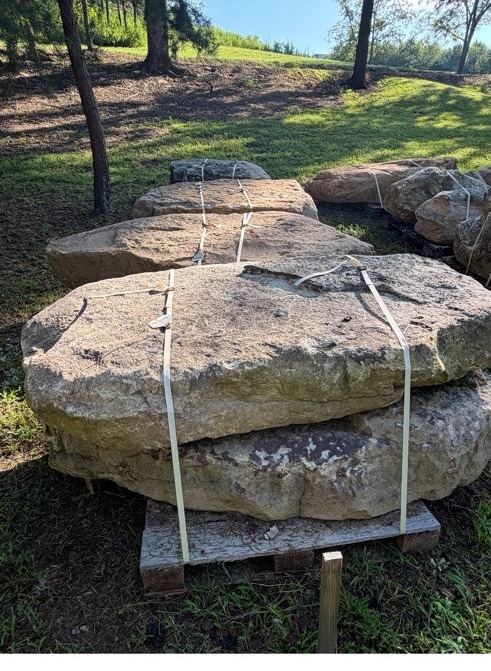 Flagstone boulders staged in the yard