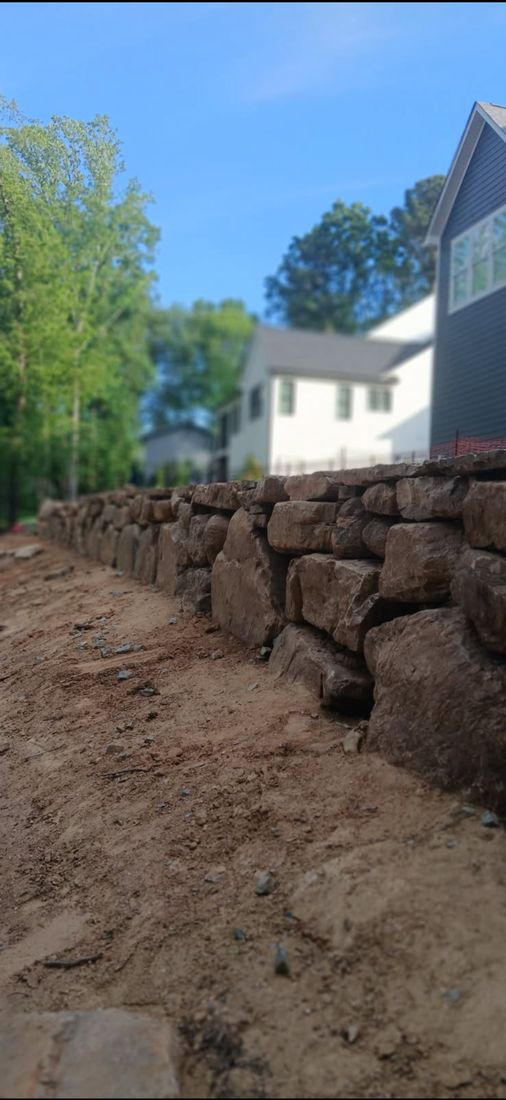 Stone wall along a path