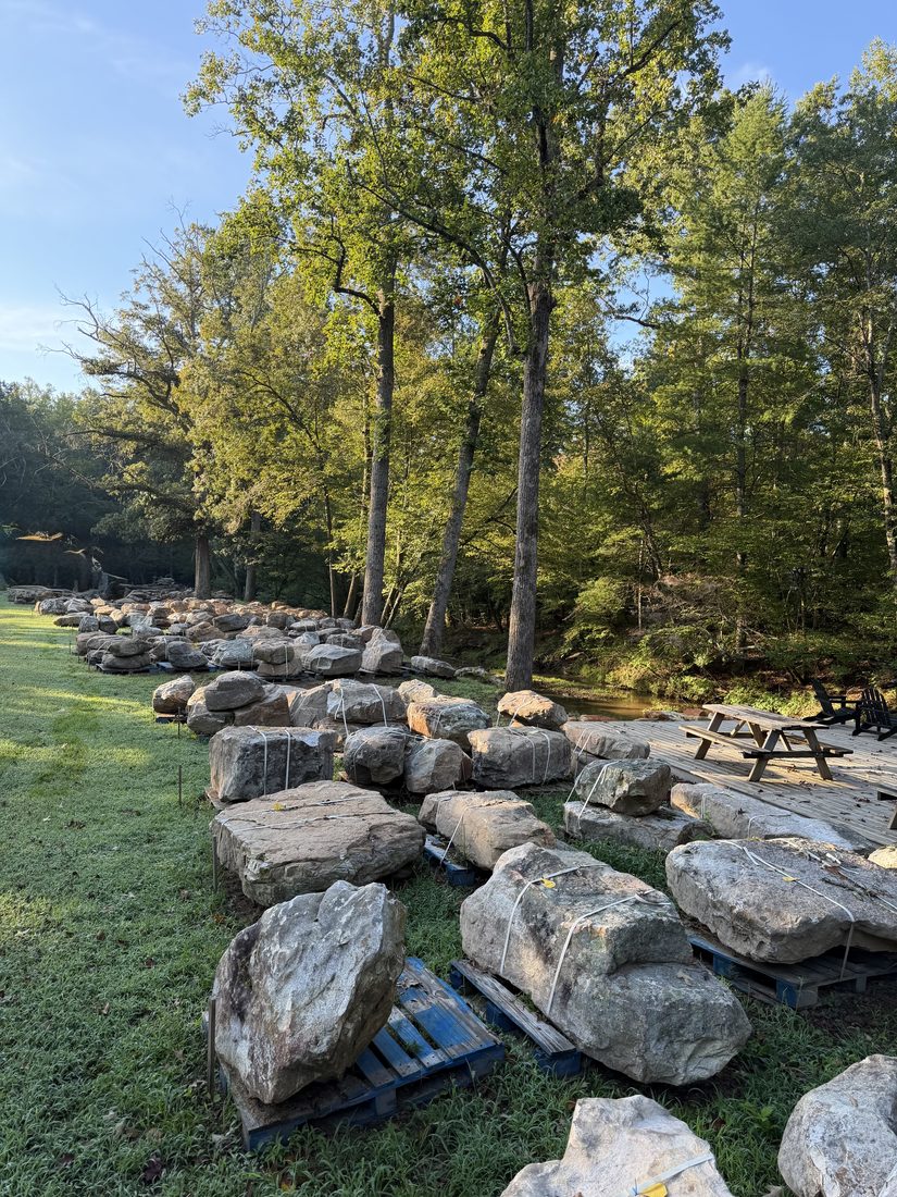 Palletized stone lined up along the creek
