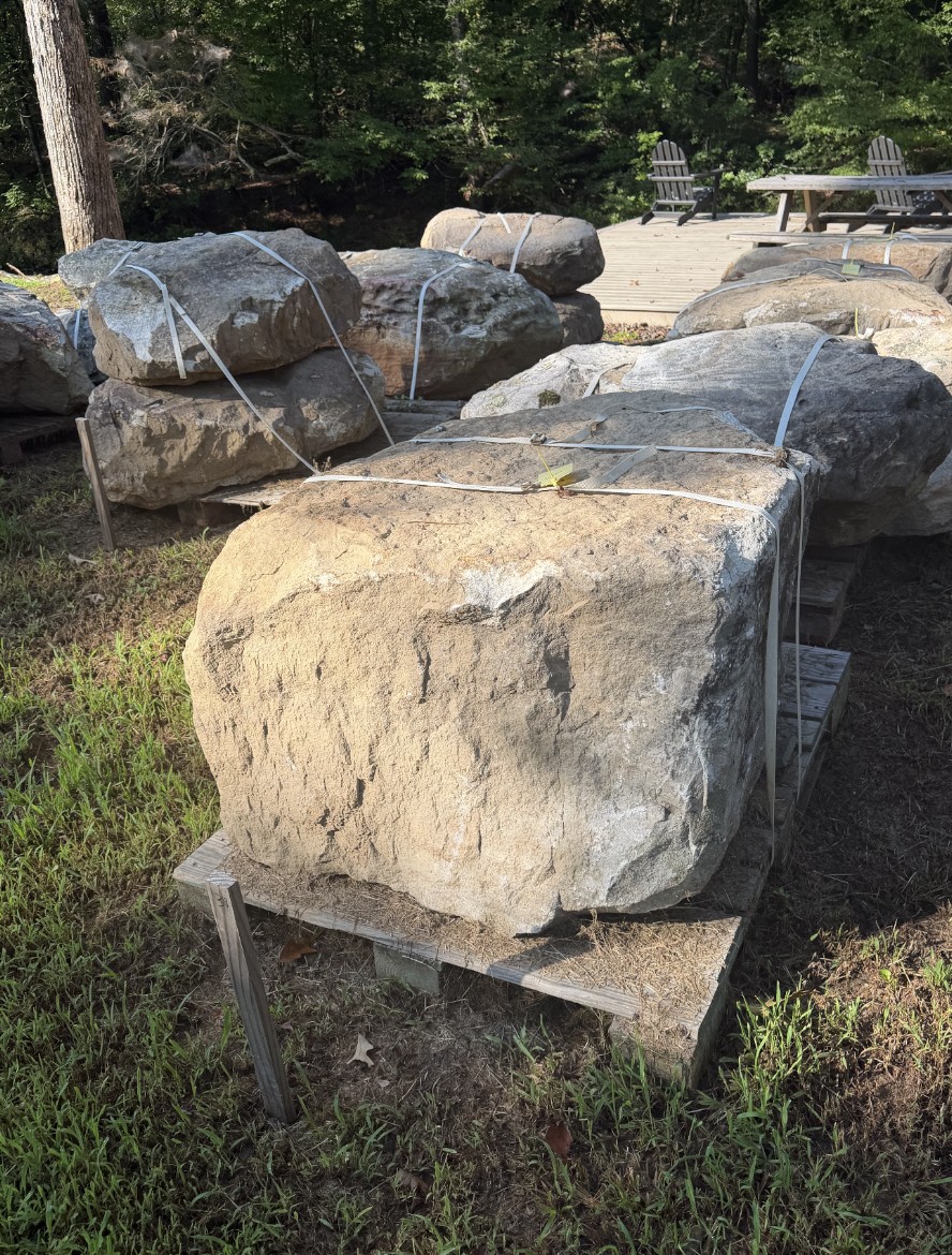 Natural boulders staged in The Stone Yard's yard